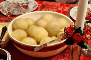 Bowl of Öland kroppkakor served with butter and lingonberries